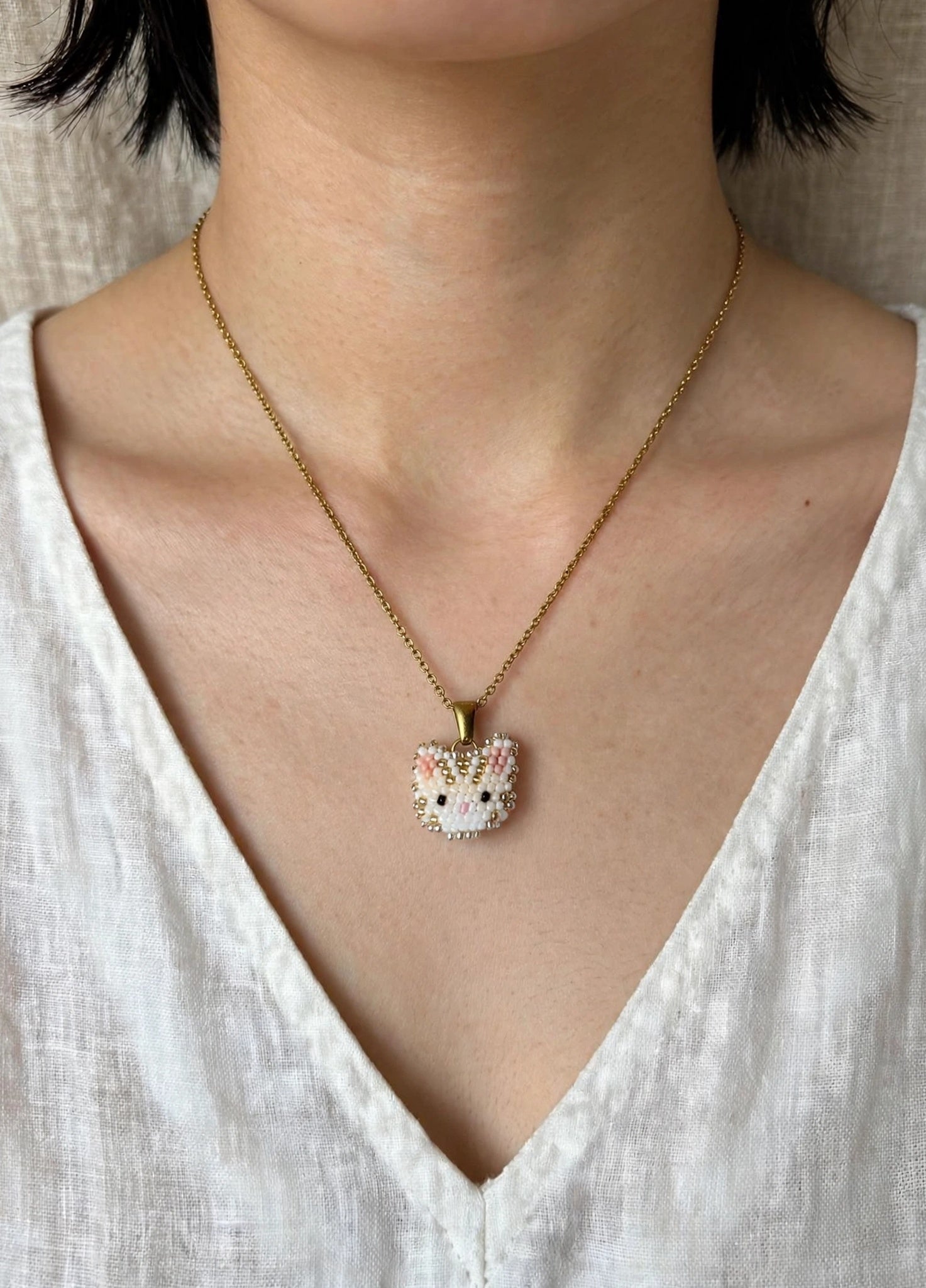 Cream tabby cat necklace on model