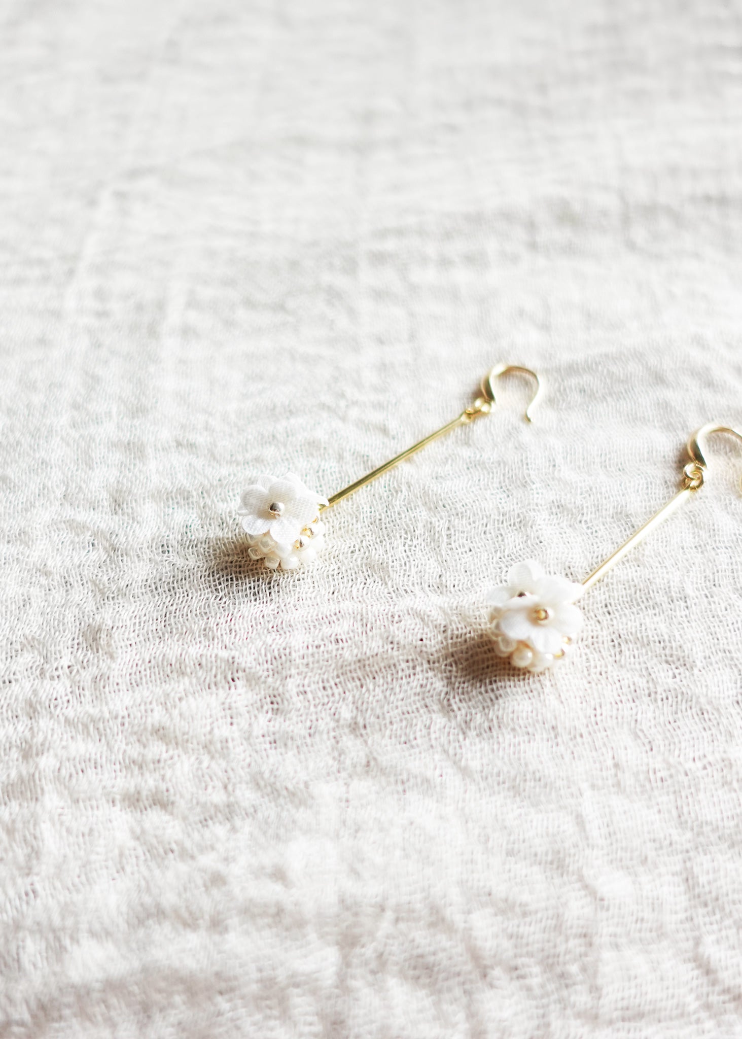 Cyme Petite Dangle Earrings in White Front