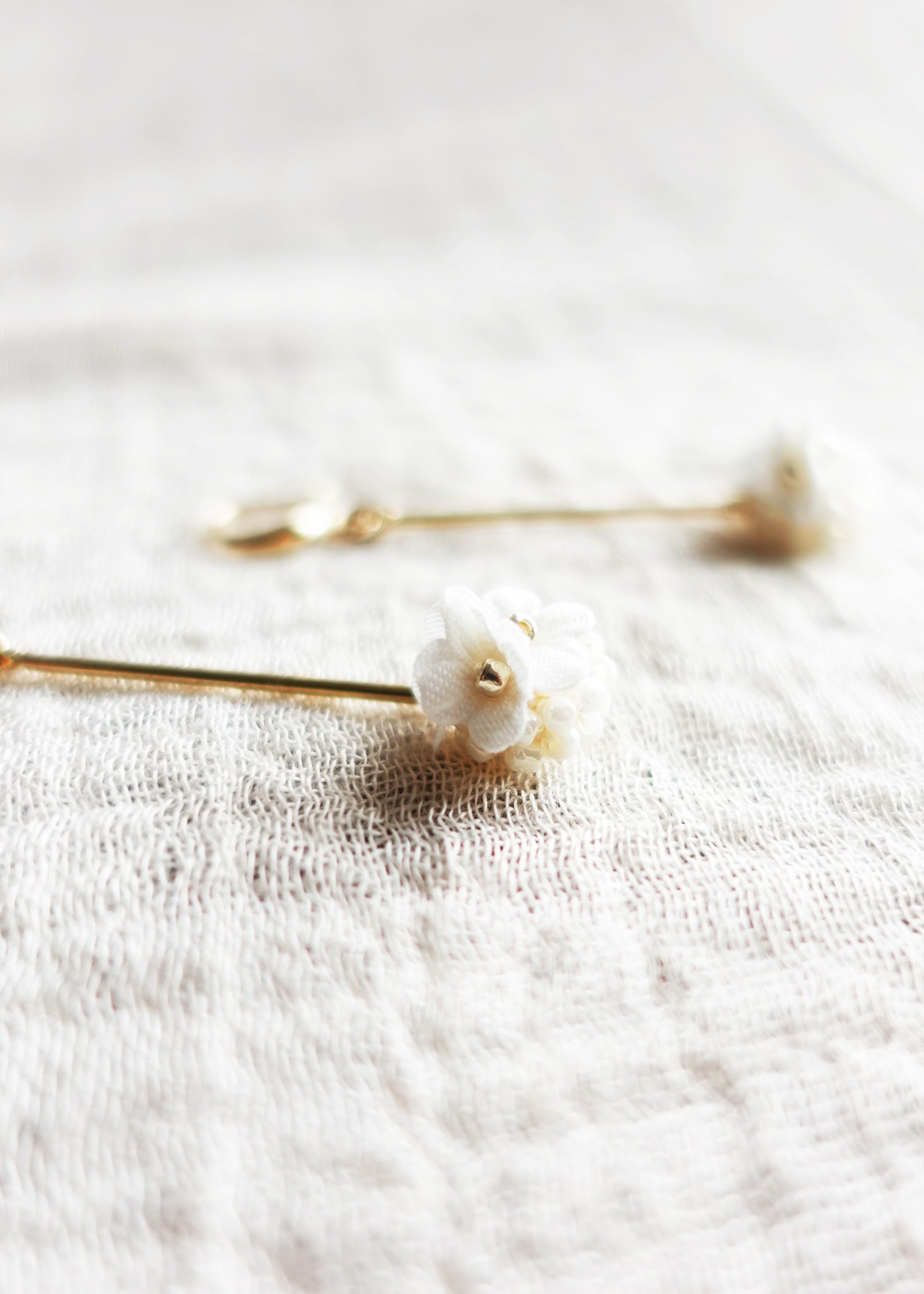 Cyme Petite Dangle Earrings in White Left Close