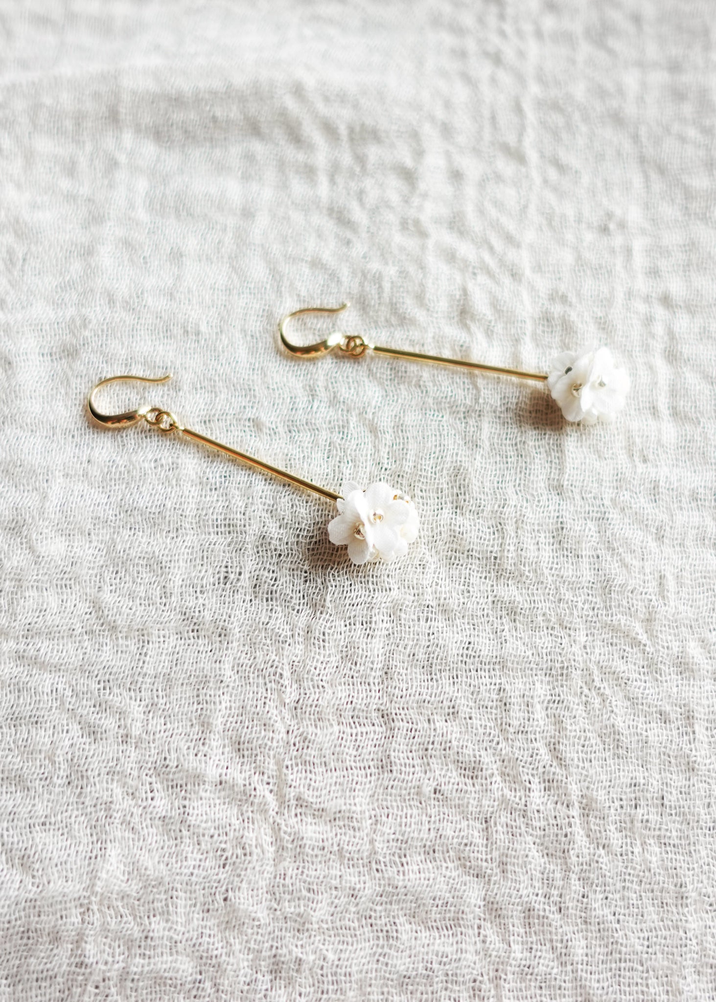 Cyme Petite Dangle Earrings in White Left Side