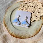 Dolphin drop earrings on card