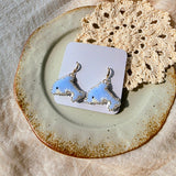 Dolphin drop earrings on card