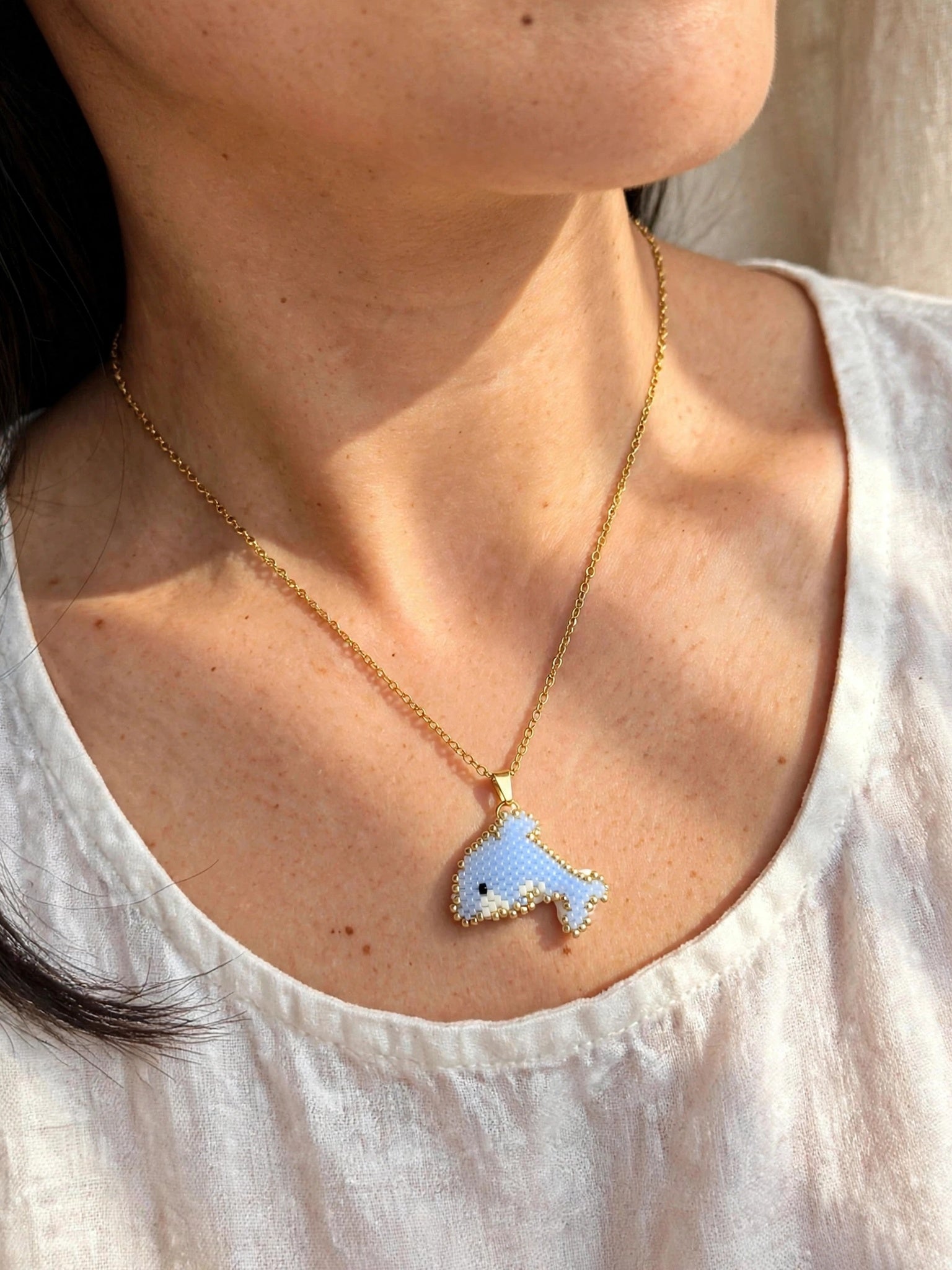 Dolphin necklace on model