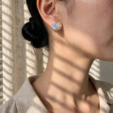 Fleur d'Or Stud Earrings in Blue on Model