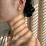 Fleur d'Or Stud Earrings in Coral on Model