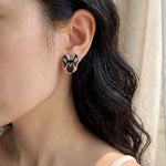 German shepherd stud earrings on model