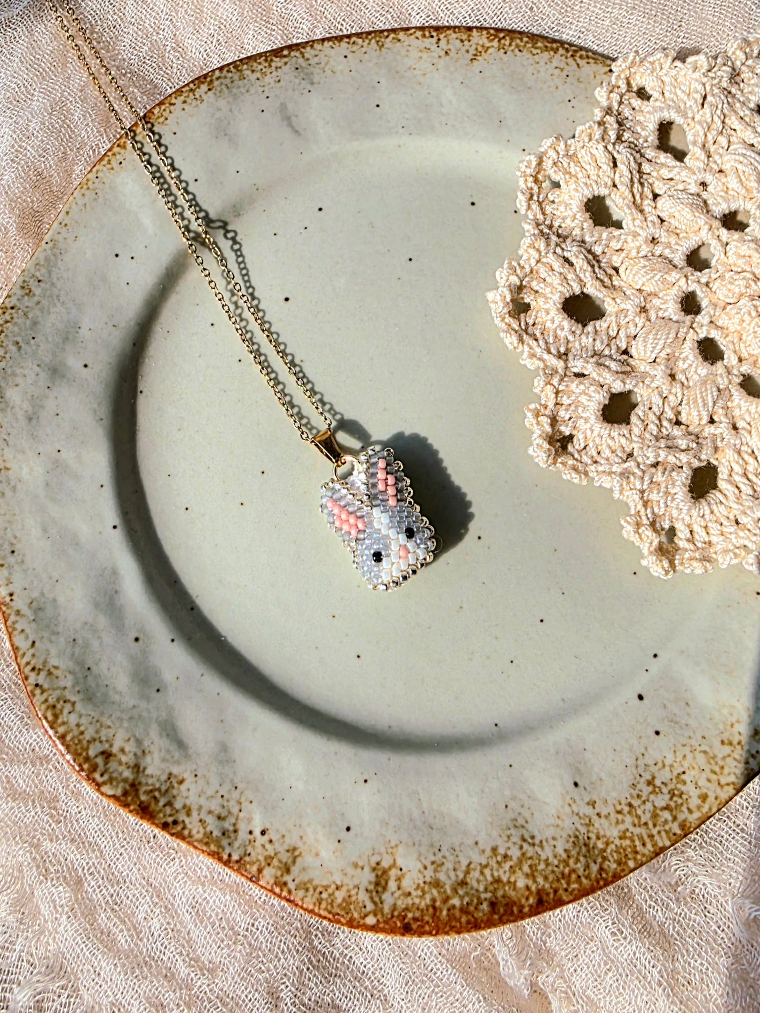 Grey bunny necklace left