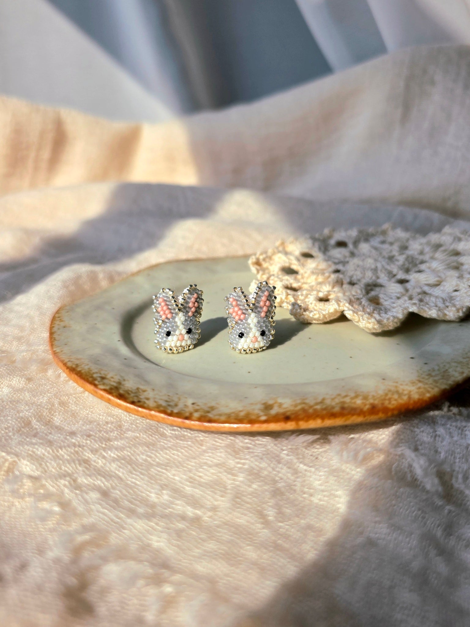 Grey bunny stud earrings front