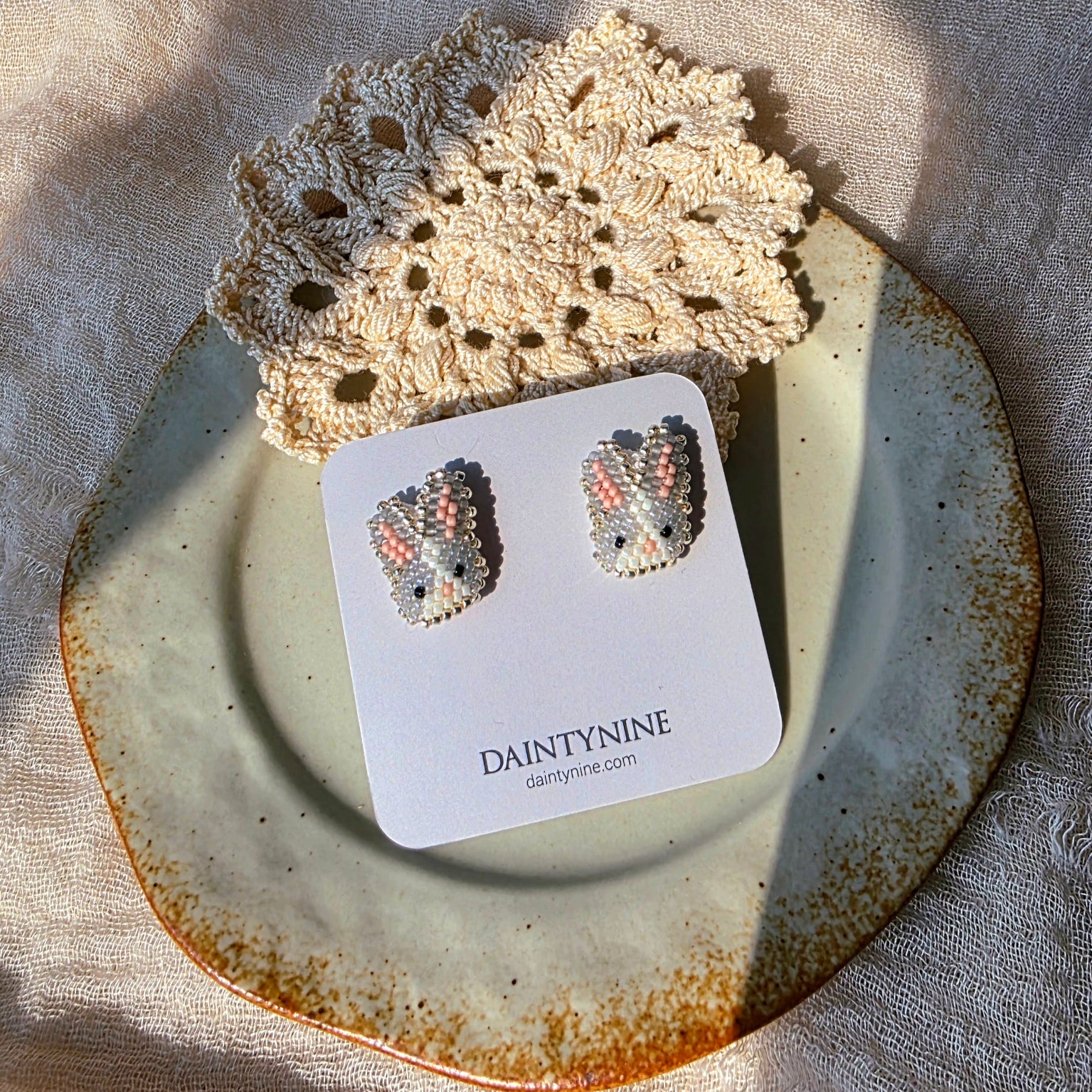 Grey bunny stud earrings on card