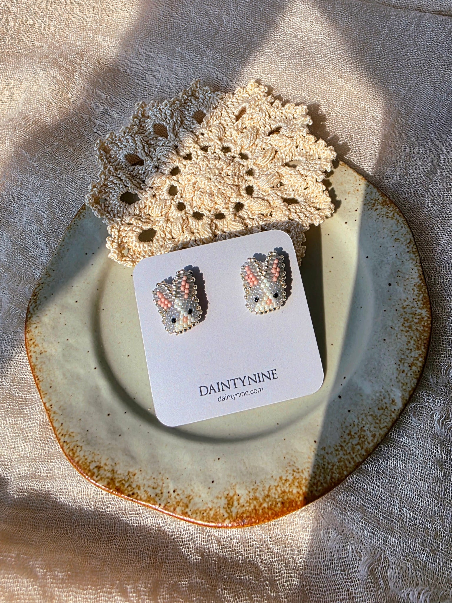 Grey bunny stud earrings on card