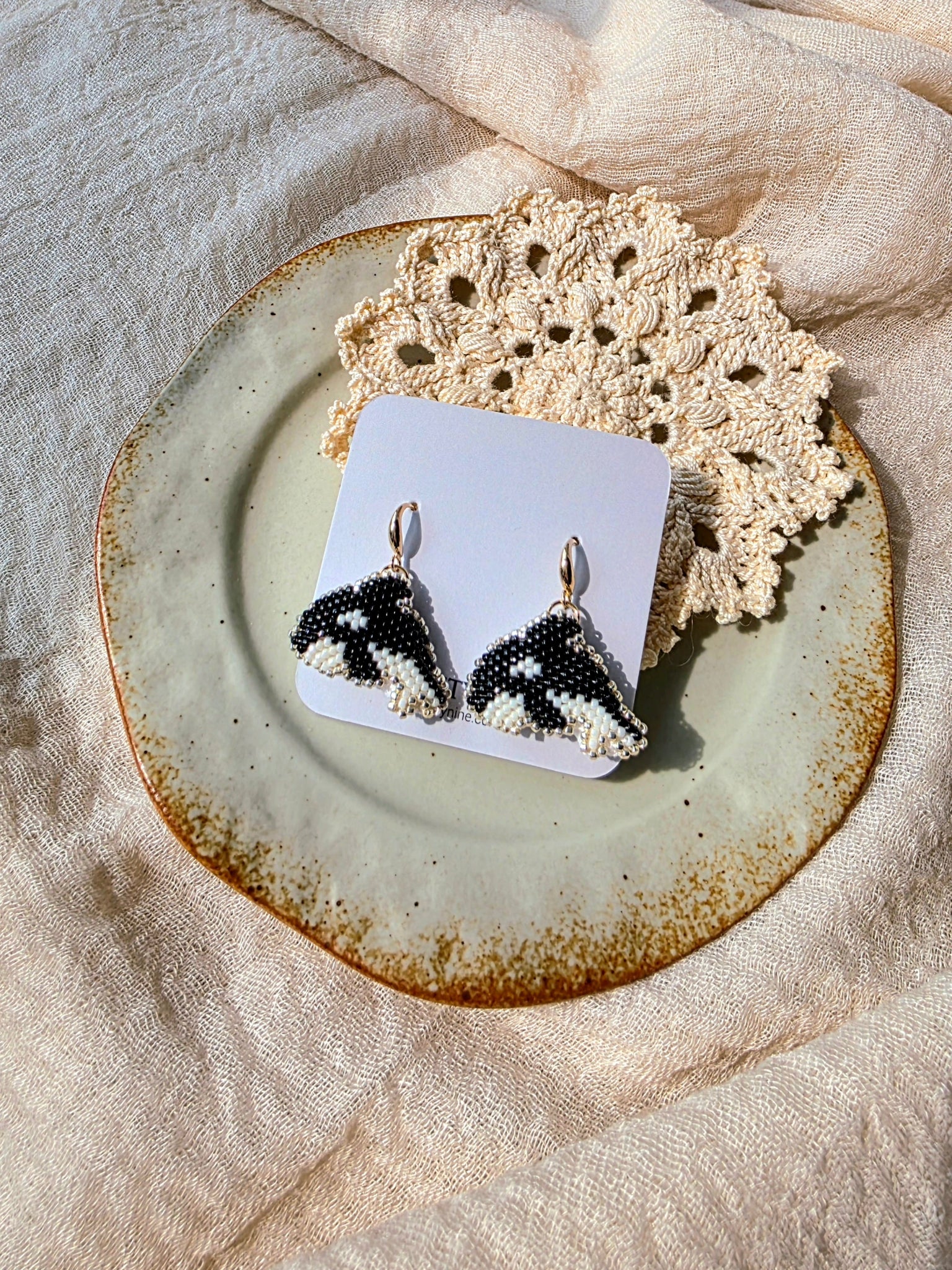 Killer whale drop earrings on card