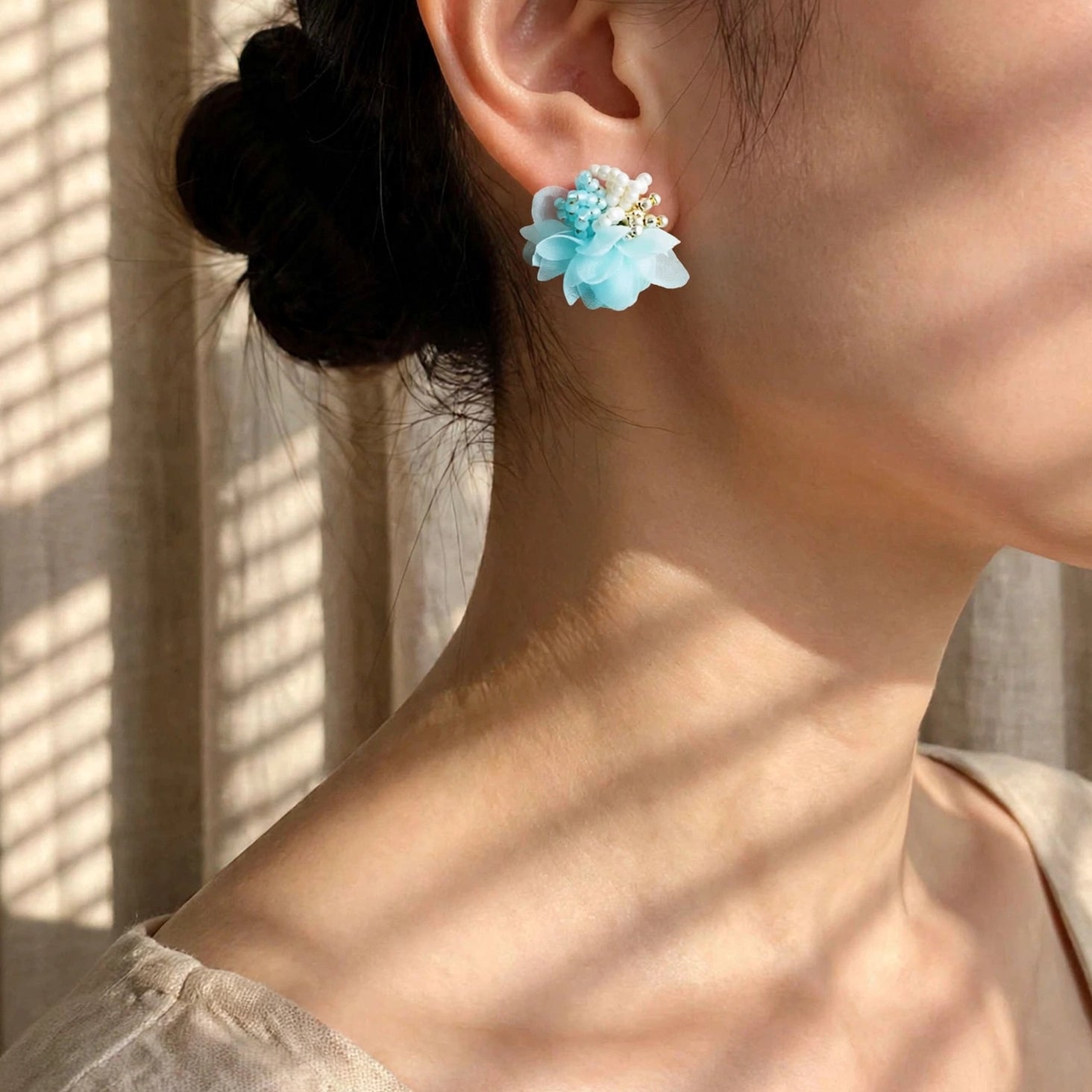 Luna Bloom Stud Earrings in Light Blue on Model