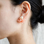 Luna Bloom Stud Earrings in Orange on model