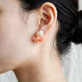 Luna Bloom Stud Earrings in Orange on model