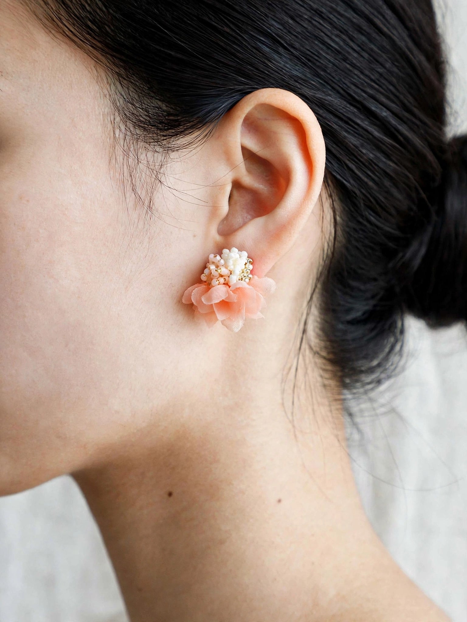 Luna Bloom Stud Earrings in Orange on model