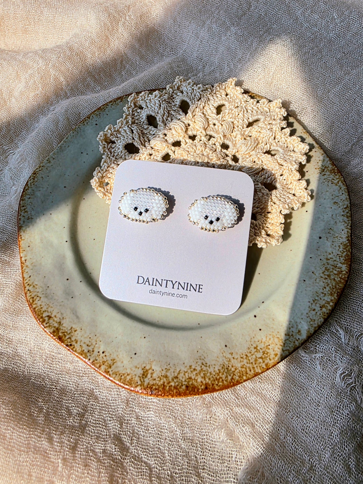 Maltese stud earrings on card
