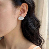 Maltese stud earrings on model