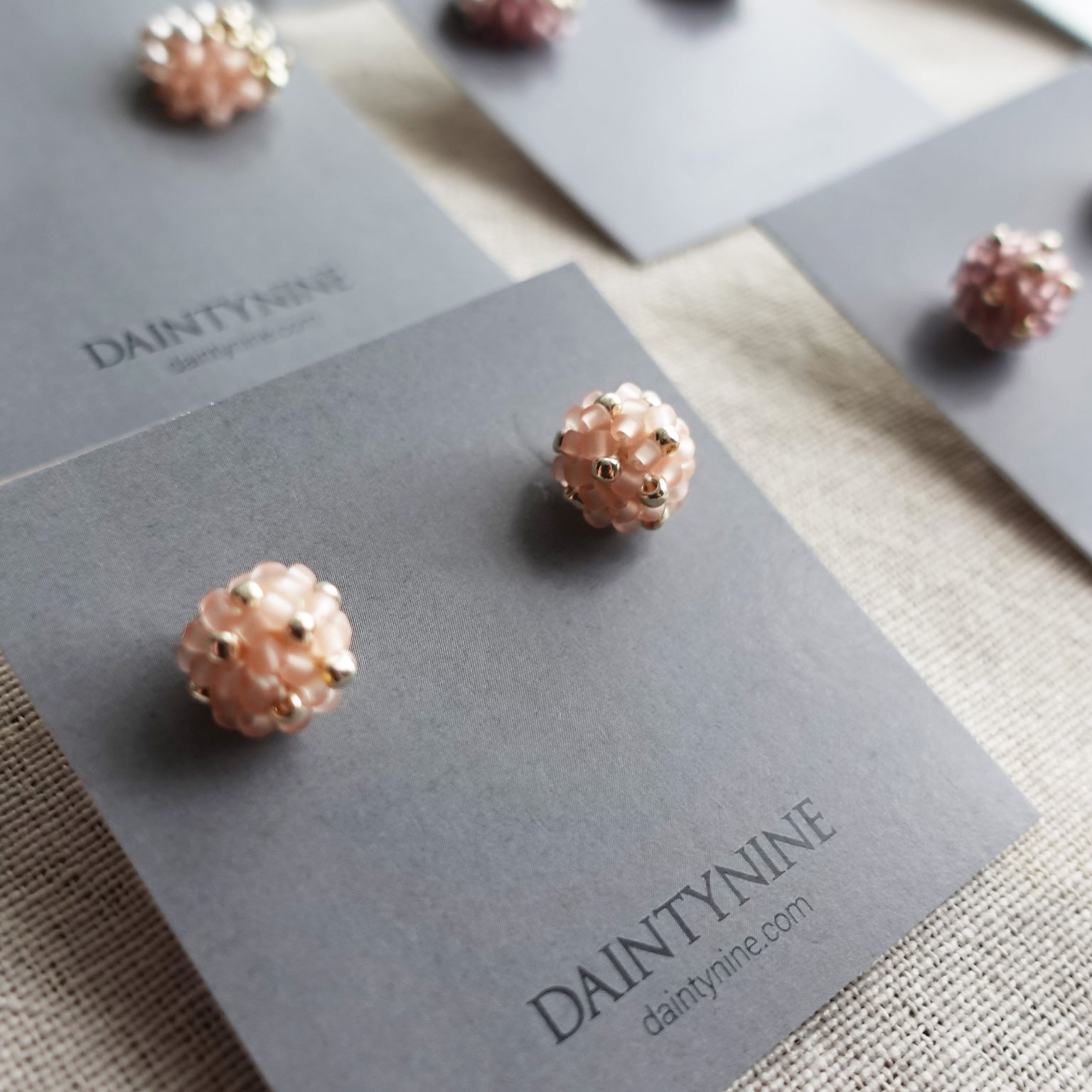 Orb Star Dust Stud Earrings in Blush Pink Card Close Up