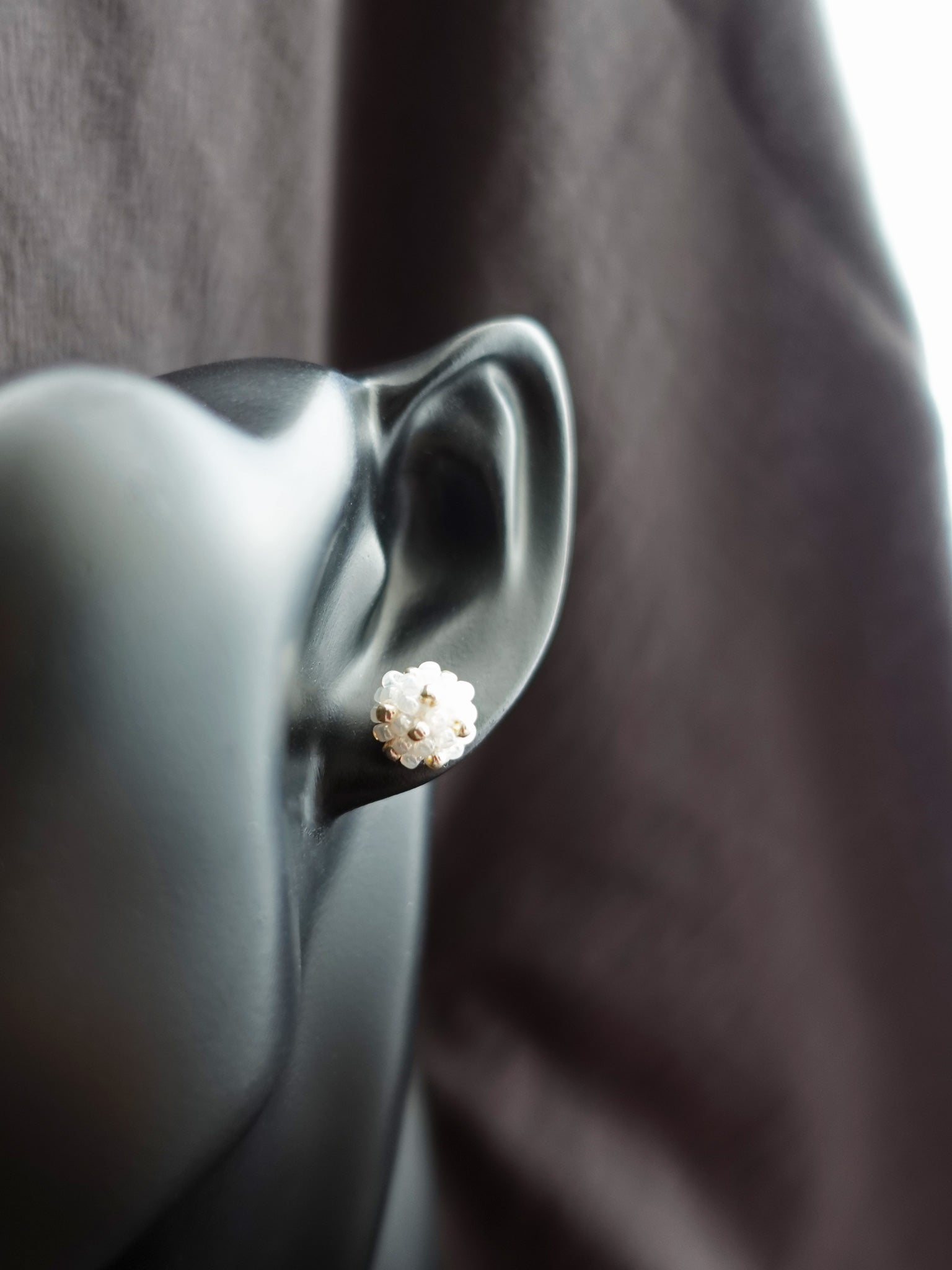 Orb Star Dust Stud Earrings in White Bust