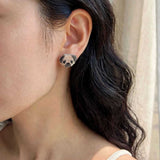 Pug stud earrings on model