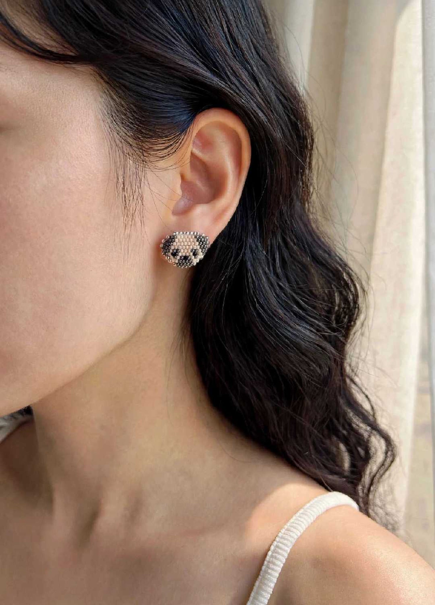 Pug stud earrings on model