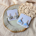 Shark and dolphin drop earrings on cards