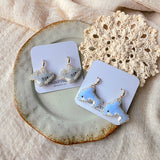 Shark and dolphin drop earrings on cards