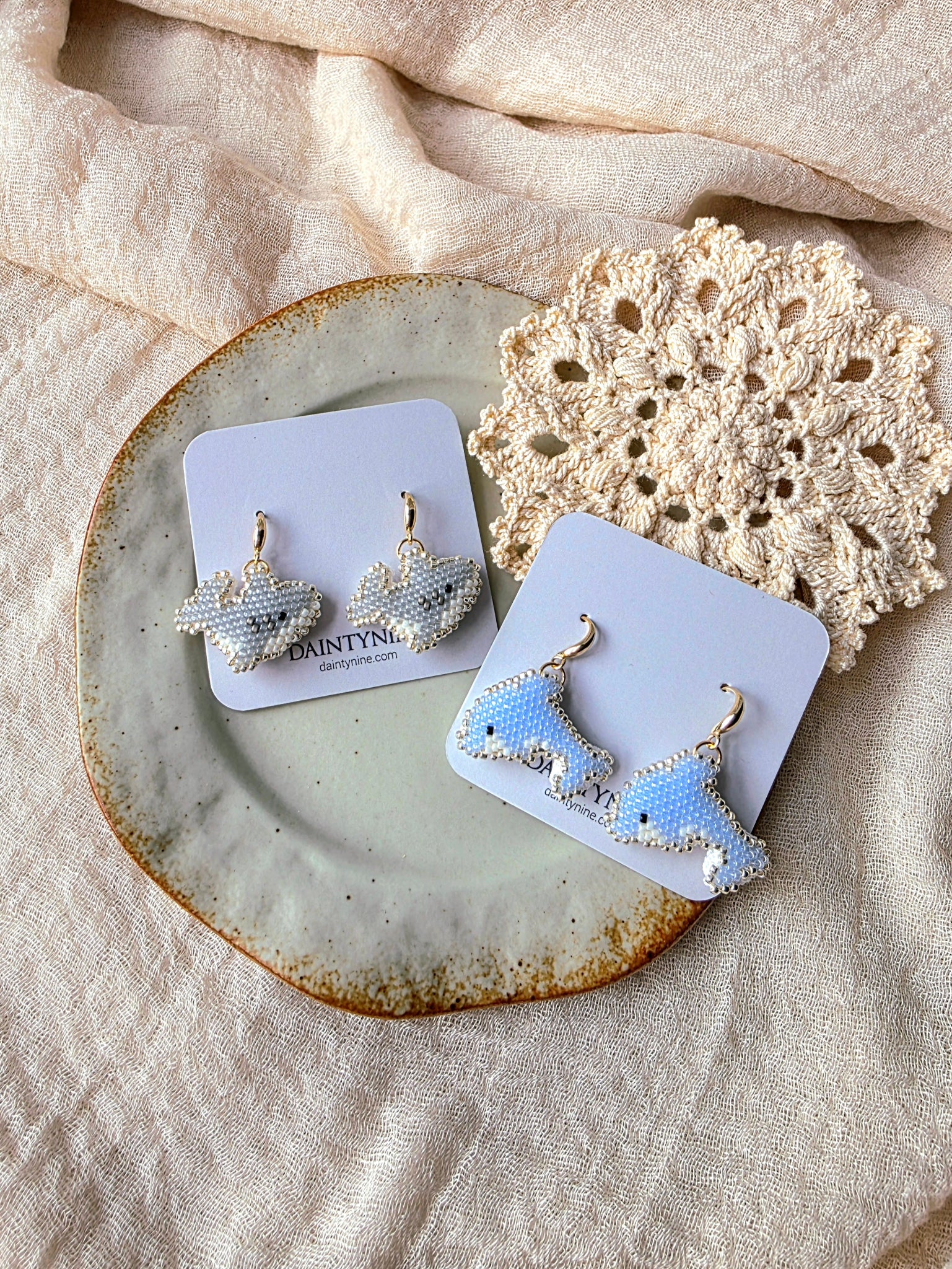 Shark and dolphin drop earrings on cards