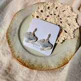 Shark drop earrings on card