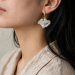 Shark drop earrings on model