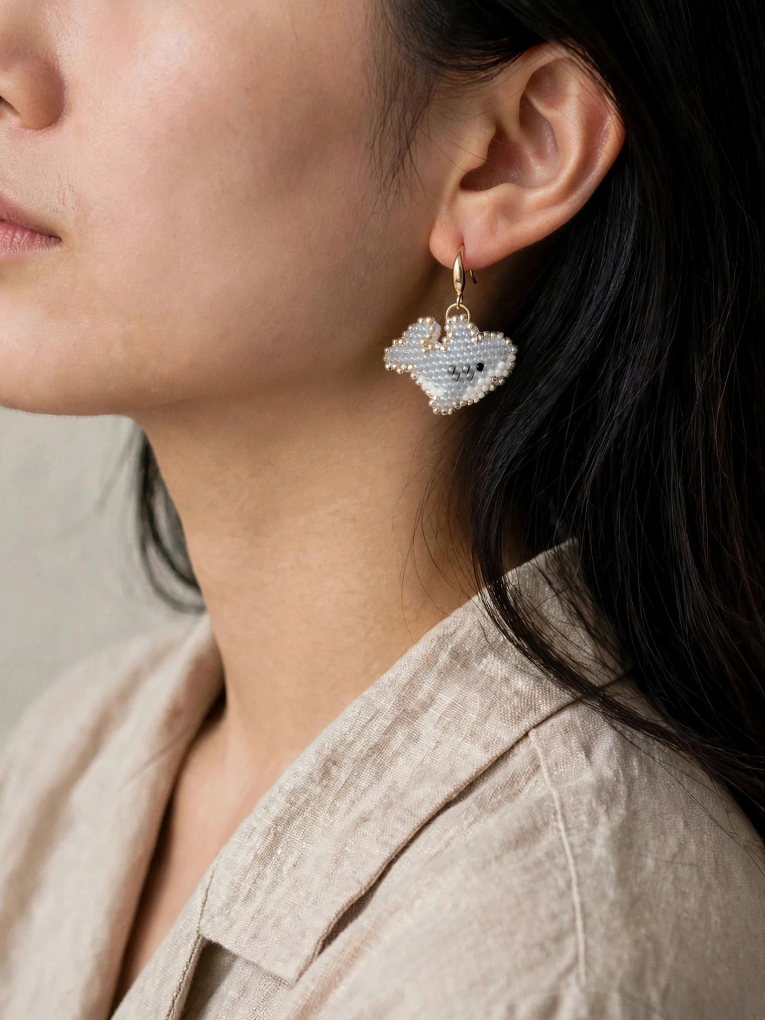 Shark drop earrings on model