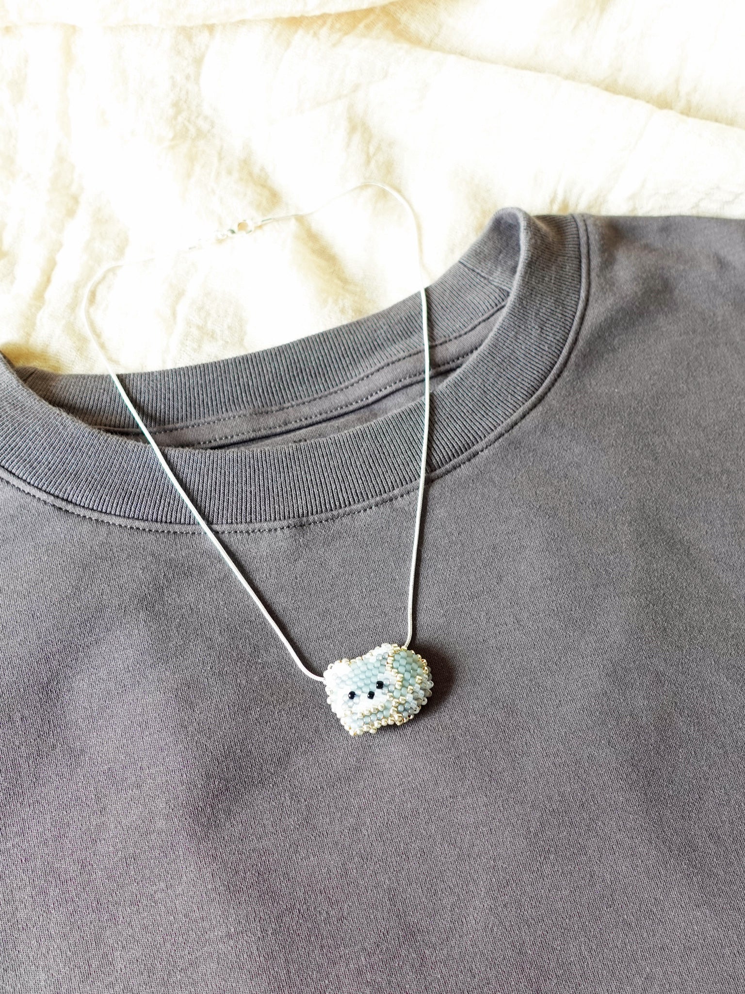 Small Raccoon Loaf Necklace Shirt Left