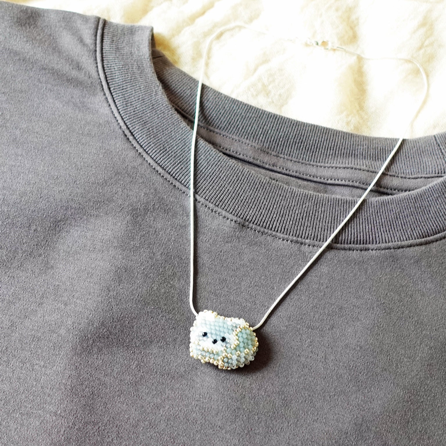Small Raccoon Loaf Necklace Shirt Right