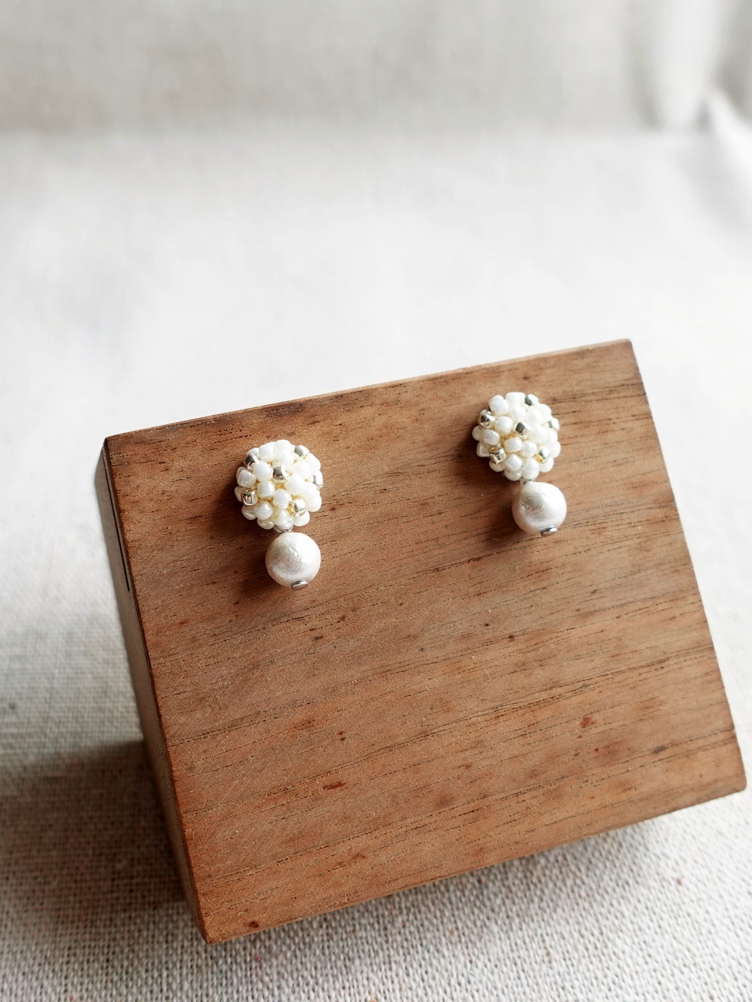 Snowball Star Dust Earrings in Pearl White Display