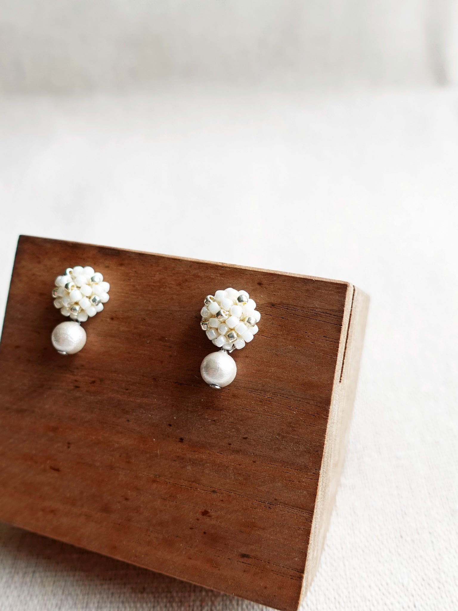 Snowball Star Dust Earrings in Pearl White Display