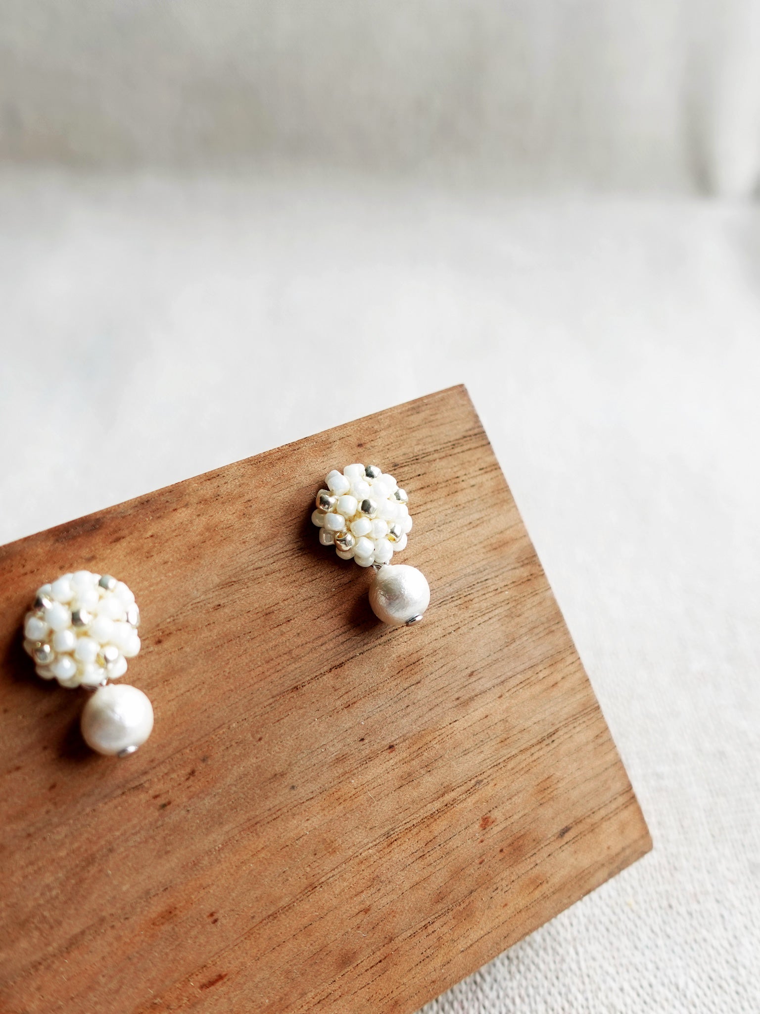 Snowball Star Dust Earrings in Pearl White Display