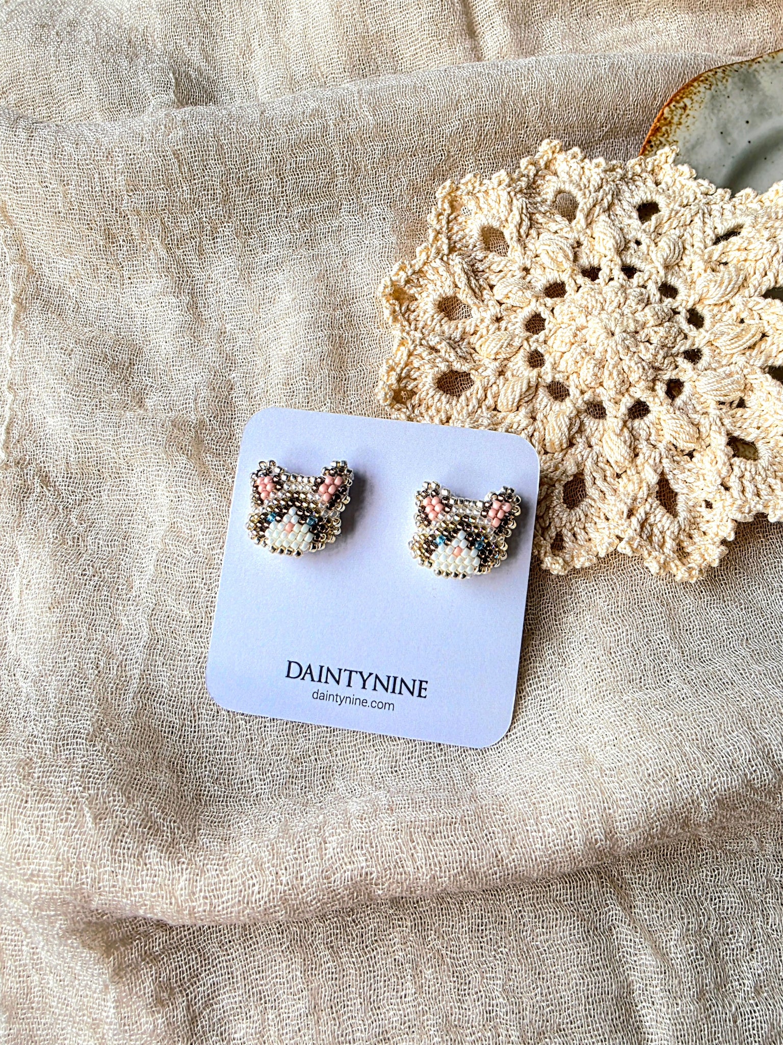Snowshoe cat stud earrings on cards