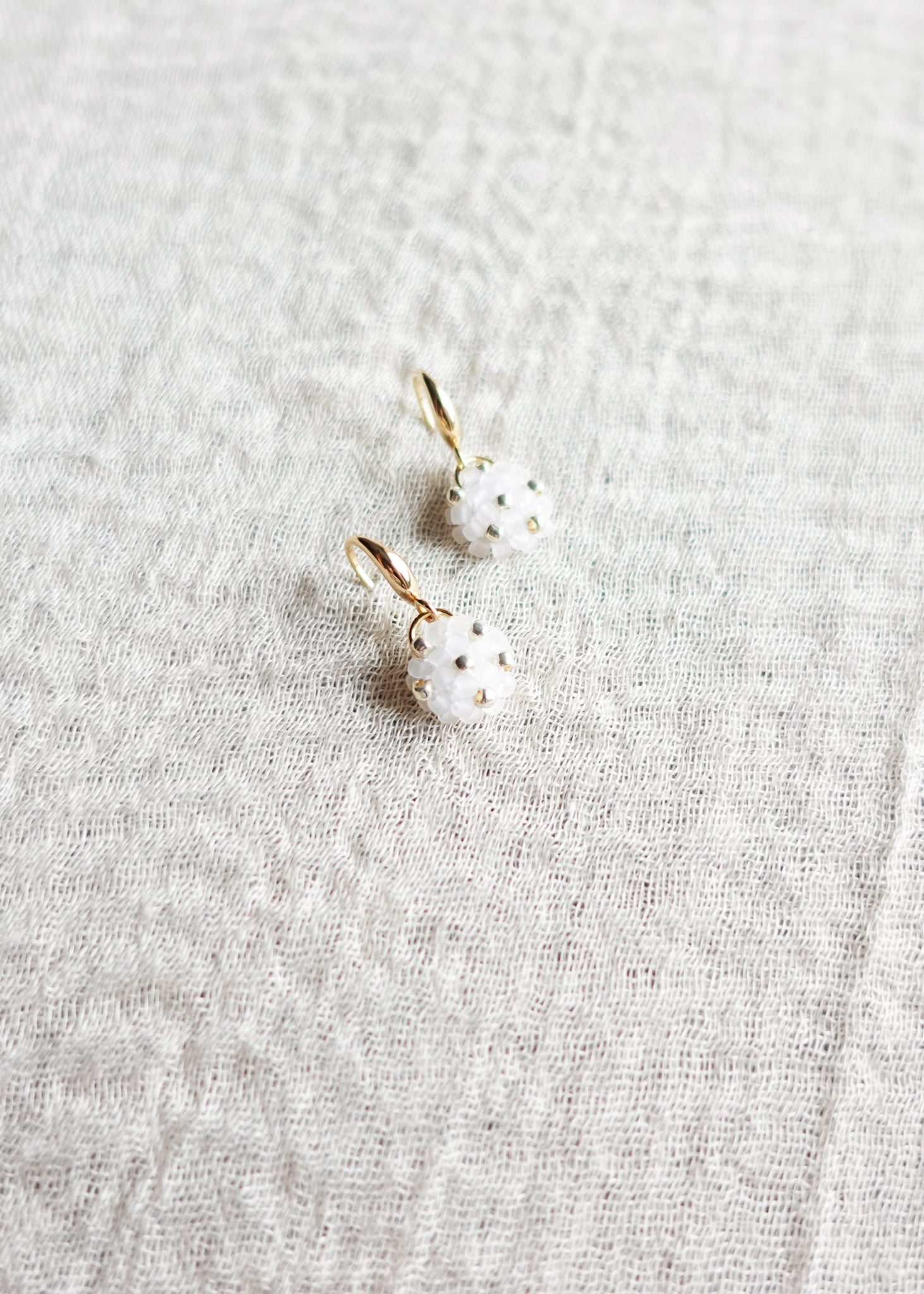 Star Dust Petite Drop Earrings in Cloud White Left Top