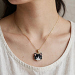 Tuxedo cat necklace on model 2