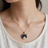 Tuxedo cat necklace on model 2