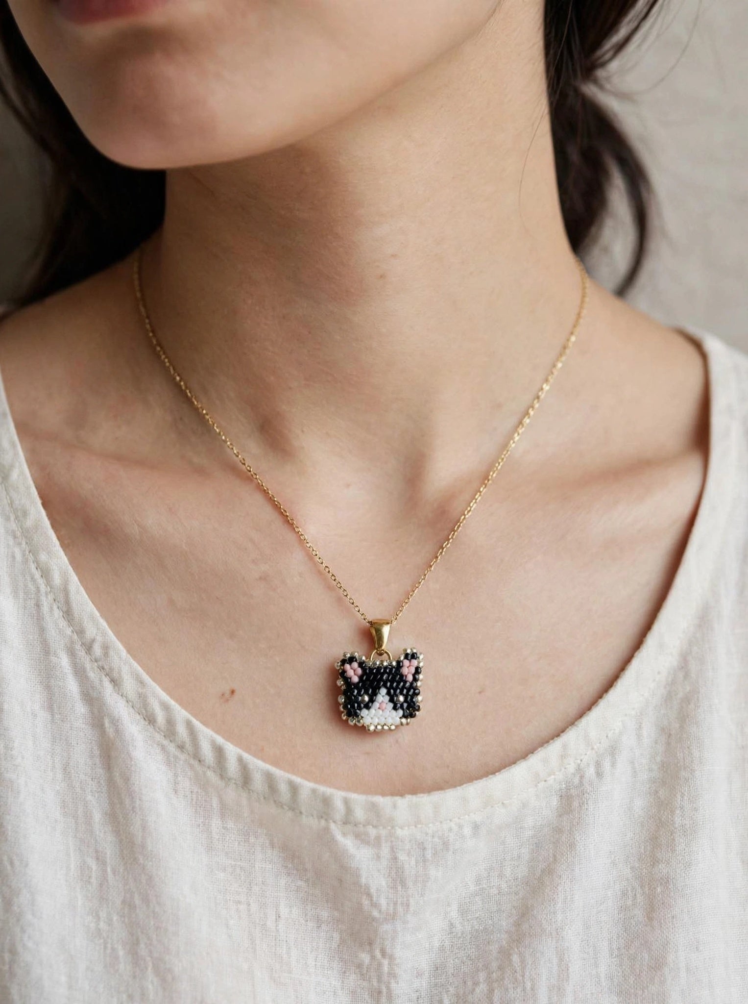 Tuxedo cat necklace on model 2