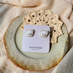 White bear stud earrings on card