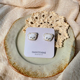 White bear stud earrings on card