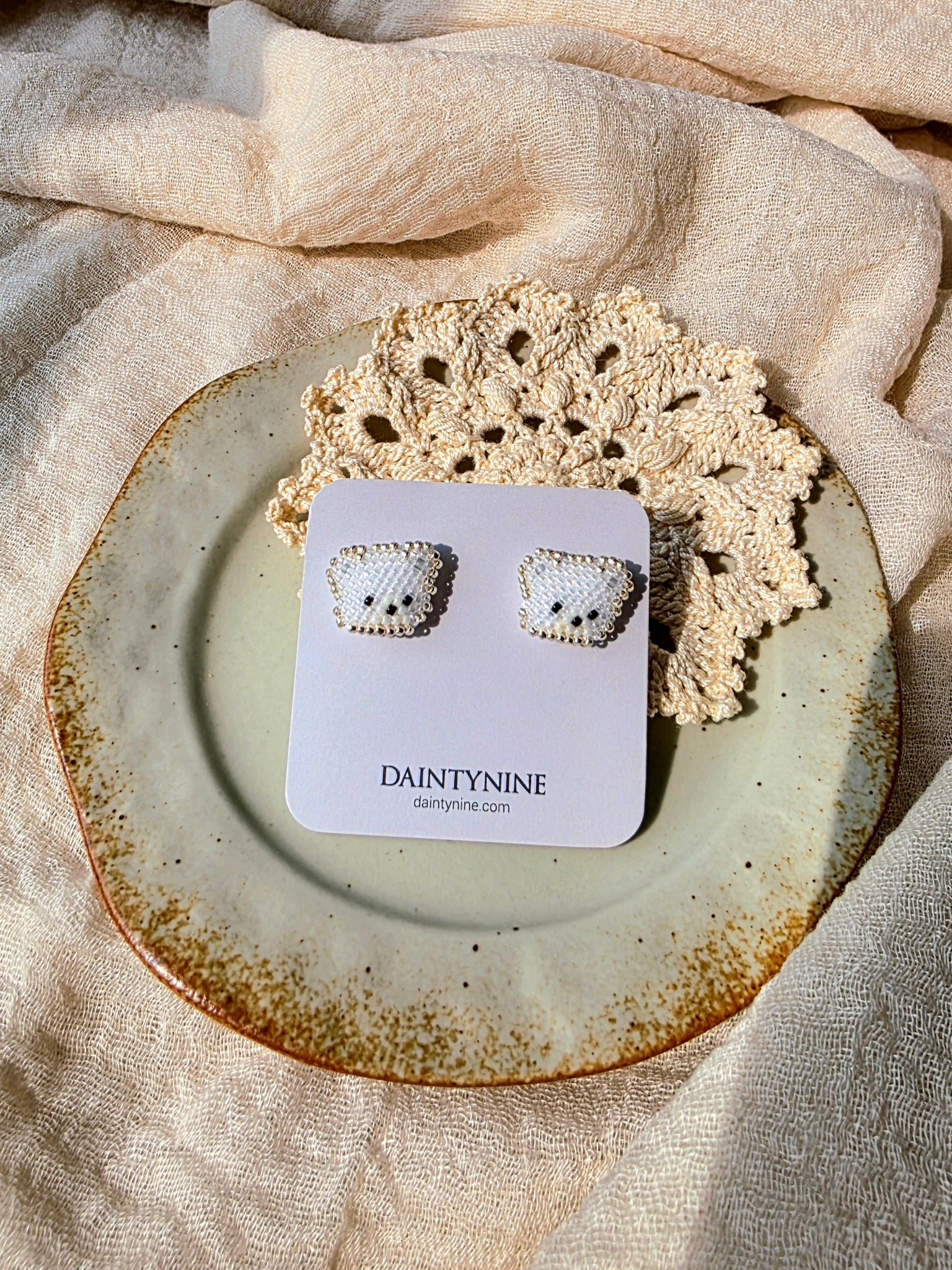 White bear stud earrings on card