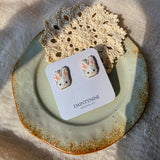 White bunny stud earrings on card