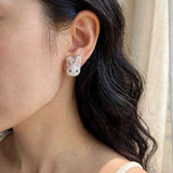 White bunny stud earrings on model