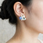 Wildpetals stud earrings in blue on model