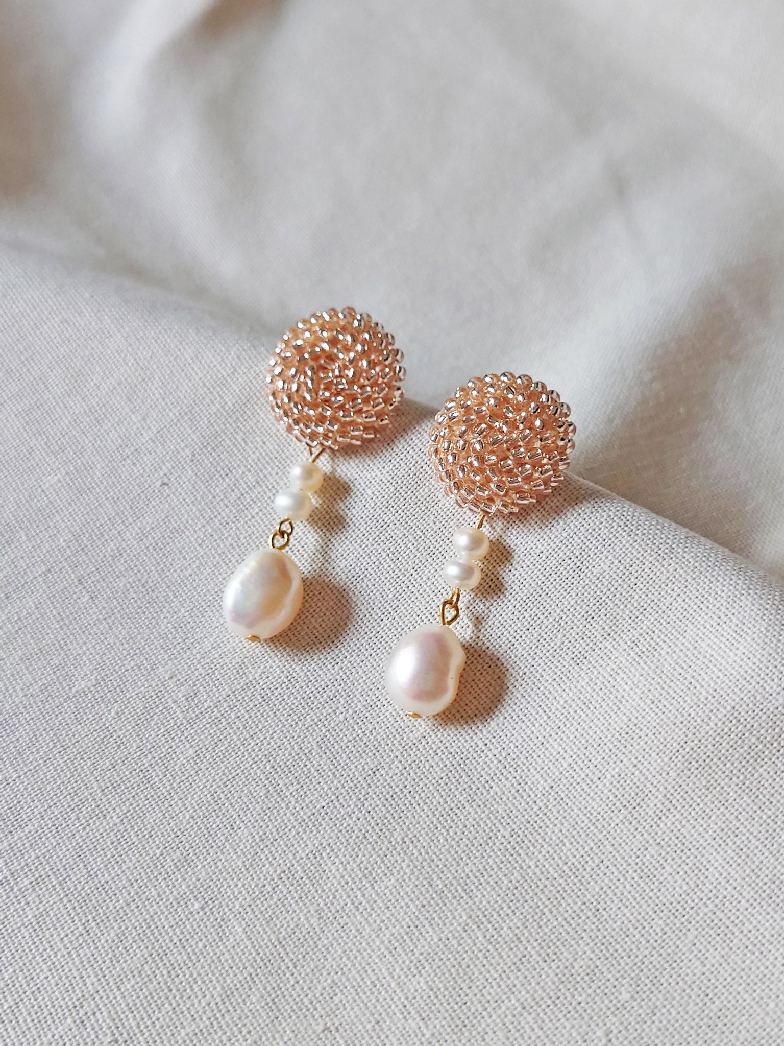 Calypso Dangle Earrings in Champagne Pink Front 1