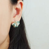Camellia Bicolor Stud Earrings in Ocean Green Model