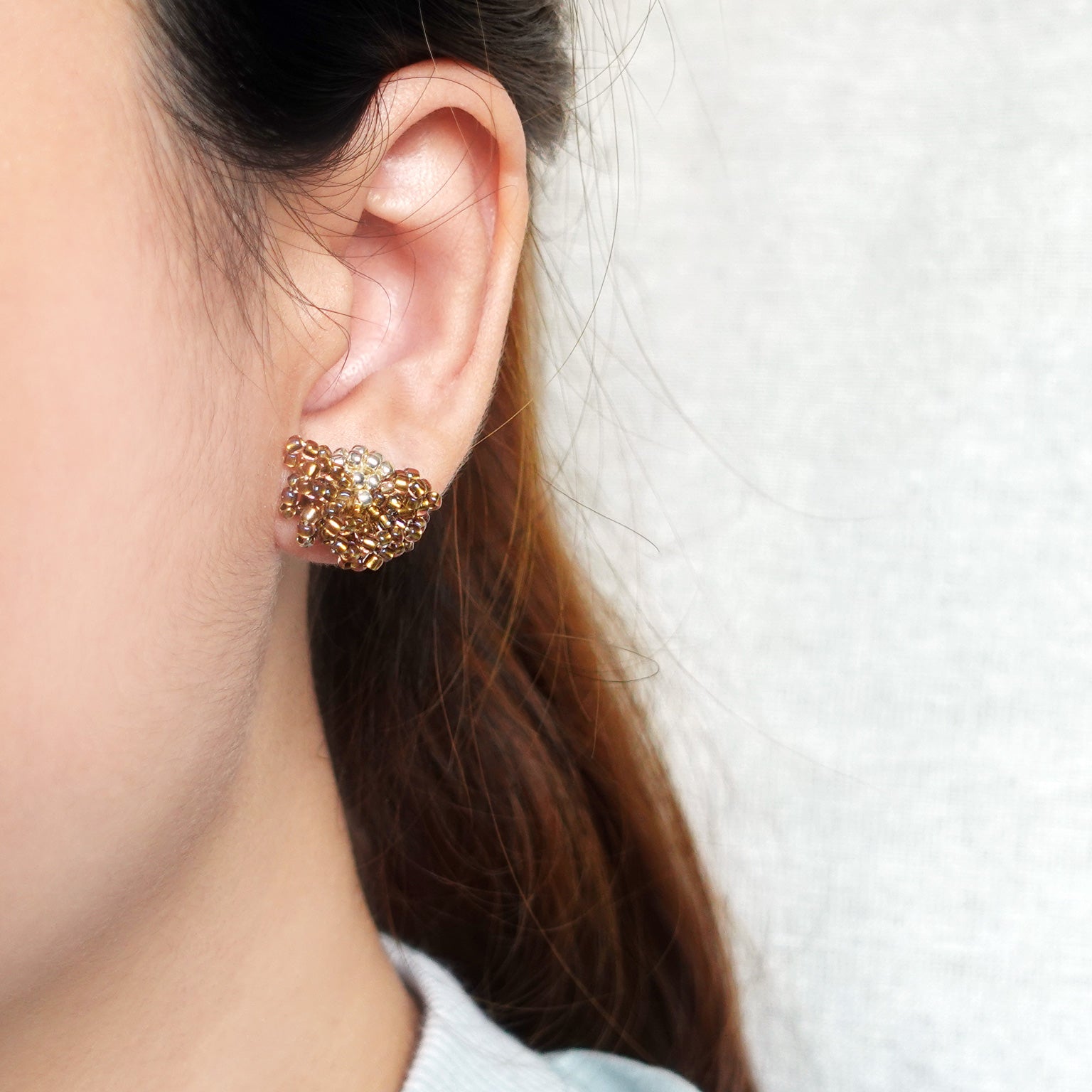 Camellia Stud Earrings in Caramel Brown Model